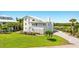 Two-story home with white exterior and landscaping at 13065 Via Aurelia, Placida, FL 33946