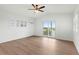 Spacious bedroom with wood-look floors and sliding glass door to balcony at 13065 Via Aurelia, Placida, FL 33946
