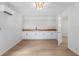 Basement kitchenette with wood countertop, white cabinets, and a sink at 13065 Via Aurelia, Placida, FL 33946