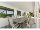 Outdoor patio with stone tile and metal table set for dining at 13065 Via Aurelia, Placida, FL 33946