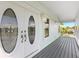 White double doors with oval glass accents and a gray porch at 13065 Via Aurelia, Placida, FL 33946