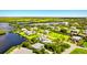 Aerial view of waterfront property with lush landscaping and private boat dock at 13065 Via Aurelia, Placida, FL 33946