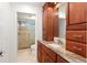 Bathroom with granite countertop, wood cabinets, and a walk-in shower at 13065 Via Aurelia, Placida, FL 33946