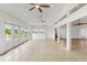 Sunroom with tile flooring, ceiling fan and access to deck at 13065 Via Aurelia, Placida, FL 33946