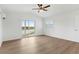 Bedroom with wood-look floors, balcony access, and water views at 13065 Via Aurelia, Placida, FL 33946