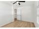 Charming bedroom with wood-look floors, ceiling fan, and access to hallway at 13065 Via Aurelia, Placida, FL 33946