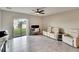 Gathering room with tiled floors, ceiling fan, and sliding door to backyard at 12730 Lemon Pepper Dr, Riverview, FL 33578