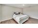 Bright bedroom featuring wood-look floors and a comfortable bed at 12730 Lemon Pepper Dr, Riverview, FL 33578
