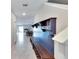 View of entryway, showing built-in bench and shoe storage, and a view into the living and dining area at 12730 Lemon Pepper Dr, Riverview, FL 33578
