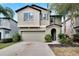Two story house with a two-car garage and landscaping at 12730 Lemon Pepper Dr, Riverview, FL 33578