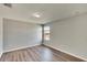 Bright bedroom with wood-look floors and large window at 12730 Lemon Pepper Dr, Riverview, FL 33578