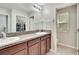Double vanity bathroom with granite countertop and walk-in shower at 12730 Lemon Pepper Dr, Riverview, FL 33578