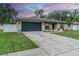 Tan house with dark gray garage door and landscaping at 739 Isleton Dr, Brandon, FL 33511