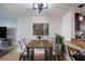 Modern dining area featuring a rustic wood table and metal chairs at 4837 Puritan Cir # 2505, Tampa, FL 33617