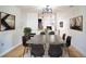 Contemporary dining area with concrete table and dark chairs at 4837 Puritan Cir # 2505, Tampa, FL 33617