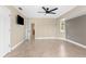 Bright bedroom with tile flooring, ceiling fan and access to the bathroom at 2558 Oberon Rd, Englewood, FL 34224