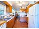 Kitchen with wood cabinets, double sink, and hardwood floors at 1479 S Evergreen Ave, Clearwater, FL 33756