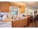 Kitchen features wood cabinets, a double sink, and views to the backyard at 1479 S Evergreen Ave, Clearwater, FL 33756