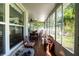 Bright sunroom with wooden furniture and large windows at 1479 S Evergreen Ave, Clearwater, FL 33756