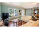 Bright living room with light walls, hardwood floors, and comfy seating at 1479 S Evergreen Ave, Clearwater, FL 33756