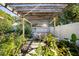 Backyard with pergola, lush landscaping and seating area at 1479 S Evergreen Ave, Clearwater, FL 33756