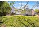 Expansive backyard with green grass and trees, offering privacy and plenty of space for recreation at 2335 W Beach St, Tampa, FL 33607