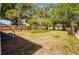 Spacious, grassy backyard with a wood fence and mature trees, perfect for outdoor activities and relaxation at 2335 W Beach St, Tampa, FL 33607