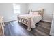 Bright bedroom featuring a light-toned bed and gray floors at 2335 W Beach St, Tampa, FL 33607