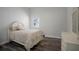 Cozy bedroom with hardwood floors, neutral decor, and ample natural light, perfect for relaxation at 2335 W Beach St, Tampa, FL 33607