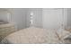 Comfortable bedroom featuring a decorative dresser, closet, and a neutral color palette at 2335 W Beach St, Tampa, FL 33607