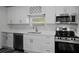 Modern kitchen featuring stainless steel appliances, white cabinets, and quartz countertops at 2335 W Beach St, Tampa, FL 33607
