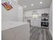 Modern kitchen with white cabinets, quartz countertops and breakfast bar at 2335 W Beach St, Tampa, FL 33607