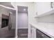 Kitchen features stainless steel refrigerator and white cabinetry at 2335 W Beach St, Tampa, FL 33607