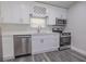 Modern kitchen featuring white shaker cabinets, stainless steel appliances, and quartz countertops at 2335 W Beach St, Tampa, FL 33607