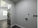 Laundry room with stainless steel refrigerator and washer/dryer hookups at 2335 W Beach St, Tampa, FL 33607