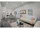 Bright open-concept living space with modern decor, including white furniture and grey-toned hardwood flooring at 2335 W Beach St, Tampa, FL 33607