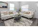 Bright living room with white couches, glass coffee table, and area rug at 2335 W Beach St, Tampa, FL 33607
