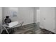 Bright home office space features wood floors, a modern glass desk, and a view into the en suite bathroom at 2335 W Beach St, Tampa, FL 33607