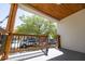 Covered porch overlooking the street with wood railings and stairs at 2335 W Beach St, Tampa, FL 33607