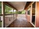 Covered deck with wooden dining table and chairs, offering an outdoor dining space at 4203 W Flora St, Tampa, FL 33614