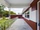 Covered porch with a white railing and brick columns at 2910 N 33Rd St, Tampa, FL 33605