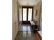 Bright entryway with double doors and a mid-century bench at 3301 W Corona St, Tampa, FL 33629