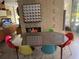 Mid-century dining area with a glass-top table and colorful chairs at 3301 W Corona St, Tampa, FL 33629
