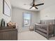 Bright Bedroom with crib, books, and lots of natural light at 10662 Hawks Landing Dr, Land O Lakes, FL 34638