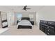 Main bedroom with dresser, bed, and large mirror at 10662 Hawks Landing Dr, Land O Lakes, FL 34638
