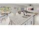Kitchen island with granite countertop, sink, and seating for four at 10662 Hawks Landing Dr, Land O Lakes, FL 34638