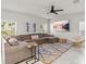 Spacious living room with sectional sofa, large TV, and a cozy chair at 10662 Hawks Landing Dr, Land O Lakes, FL 34638