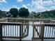 Wooden deck with gate access leading to the lake, providing a peaceful waterfront view at 7108 Waterside Dr # 103, Tampa, FL 33617