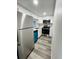 Modern kitchen with white cabinets, teal dishwasher, and stainless steel appliances at 7108 Waterside Dr # 103, Tampa, FL 33617