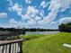 Scenic lake view with gazebo and lush green grass under a partly cloudy sky at 7108 Waterside Dr # 103, Tampa, FL 33617